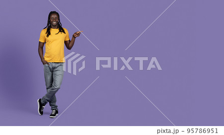 Cool african american millennial man pointing at copy space Cool african american millennial man pointing at copy space 95786951