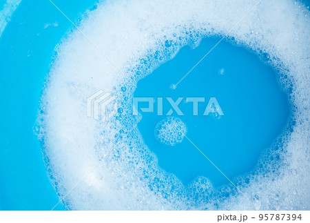 Detergent foam bubble, blue background. Detergent foam bubble, blue background. 95787394