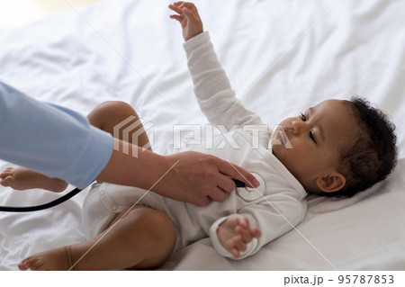 Medical Checkup. Unrecognizable Pediatrician Examining Little Black Baby With Stethoscope At Home Medical Checkup. Unrecognizable Pediatrician Examining Little Black Baby With Stethoscope At Home 95787853