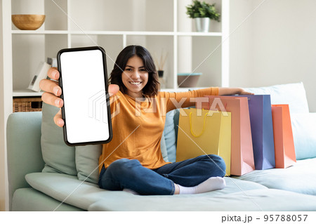Shopping App. Cheerful Young Arab Woman Demonstrating Blank Smartphone At Camera 95788057
