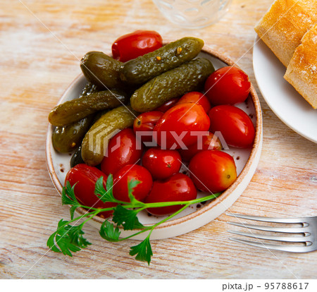 Portion of pickled tomatoes and cucumbers 95788617