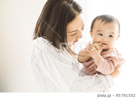赤ちゃんを抱っこする笑顔のママ 95791502