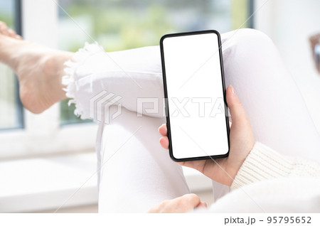 woman hand holding black cell phone smartphone with blank white screen and modern frame less design. cell mobile phone blank white screen mockup woman hand holding black cell phone smartphone with blank white screen and modern frame less design. cell mobile phone blank white screen mockup 95795652