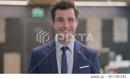 Portrait of Businessman Shaking Head as Yes Sign, Approval 95796385