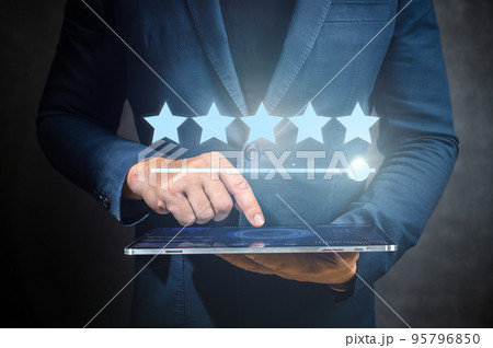 man hand holding digital tablet with 5 star icons interface. Client satisfaction survey. Five star, Good service, hotel, application, company evaluation. customer feedback. Marketing concept 95796850
