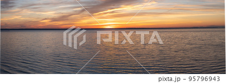The sky at sunset, twilight colors. Natural background. sunset sky panorama landscape background natural color of evening landscape with setting sun light coming through clouds panoramic view 95796943