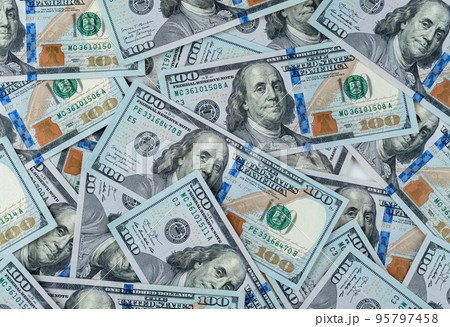 pile of one hundred US banknotes. Background with money american hundred dollar bills. 100 bills background. Lots of dollar bank notes on the table 95797458