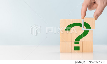 Cubes with green question marks, closeup. Space for text. hand hold Questions Mark word with wooden cube block on table background. FAQ frequency asked questions, Answer, Information Cubes with green question marks, closeup. Space for text. hand hold Questions Mark word with wooden cube block on table background. FAQ frequency asked questions, Answer, Information 95797479