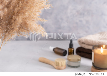 Selective soft focus. Skin care product for oil face massage and flowers on white table. Eco friendly organic reusable self care accessories. Selective soft focus. Skin care product for oil face massage and flowers on white table. Eco friendly organic reusable self care accessories. 95798941