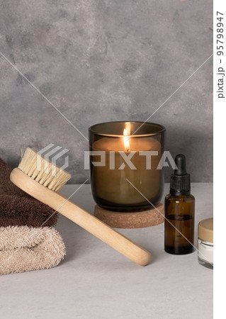 Skin care product for oil face massage and flowers on white table. Eco friendly organic reusable self care accessories. 95798947