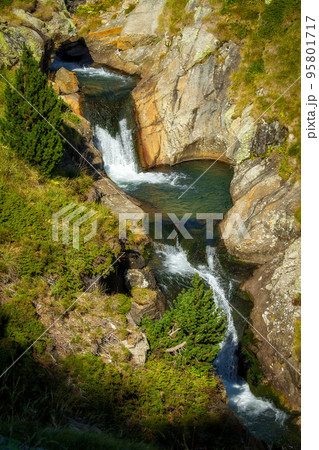 Nice mountain creek waterfalls in a Spanish Pyrenees mountain, near Vall de Nuria valley Nice mountain creek waterfalls in a Spanish Pyrenees mountain, near Vall de Nuria valley 95801717