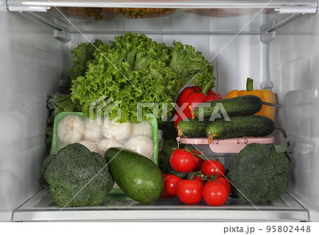 Different fresh products on shelf in refrigerator 95802448