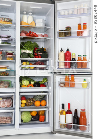 Open refrigerator full of different fresh products Open refrigerator full of different fresh products 95802449