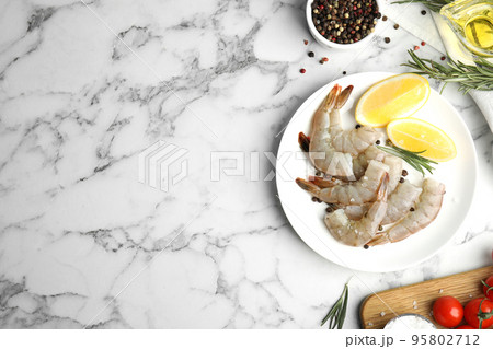 Flat lay composition with fresh raw shrimps on marble table. Space for text 95802712