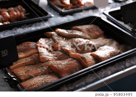 Fresh marinated fish in container on display, closeup Fresh marinated fish in container on display, closeup 95803495