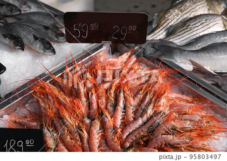 Fresh fish and shrimps on ice in supermarket Fresh fish and shrimps on ice in supermarket 95803497