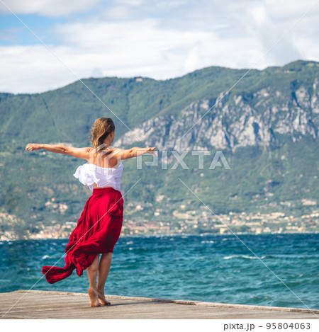 Woman walking on a pier 95804063