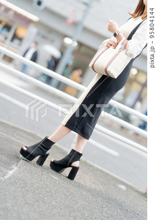 バッグを持つ若い女性の足元 95804144