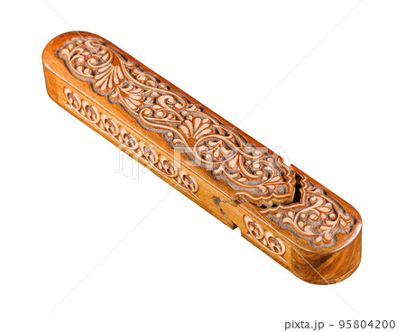 The artistic wood carving on the pencil case on a white background. Central Asia, Uzbekistan 95804200