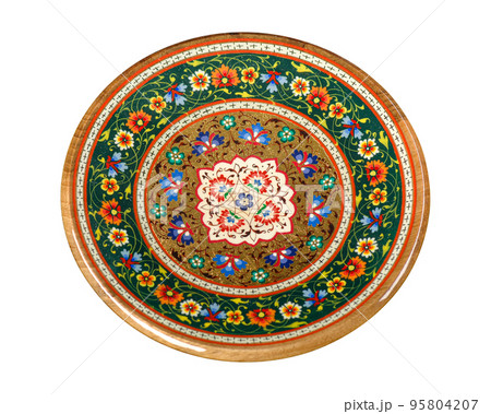 A wooden plate with artistic painting isolated on a white background 95804207