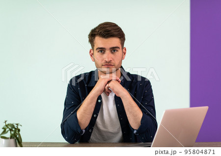 Smiling young man freelancer using laptop studying online working from home 95804871