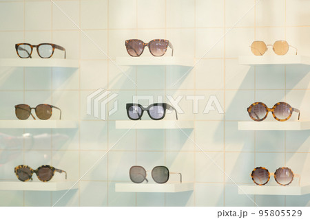 Exhibitor of glasses consisting of shelves of fashionable glasses shown at the optical shop Exhibitor of glasses consisting of shelves of fashionable glasses shown at the optical shop 95805529
