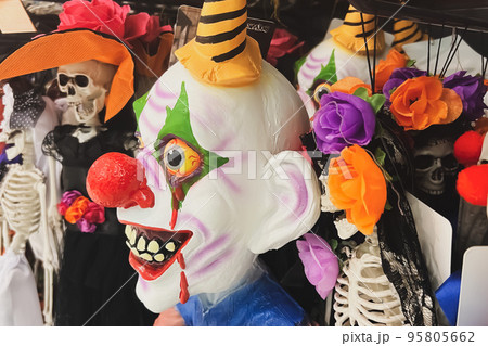 A scary clown in a shop Halloween Costume Store 95805662