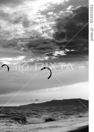 Two silhouette of power kites at sunset sky. Black and white. 95805882
