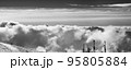 Black and white panorama of snowy ski slope in cloudy high mountains 95805884