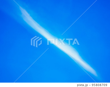 The sky was blue with white clouds streaking across the center diagonally. 95808709