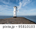 Old windmill lighthouse in Swinoujscie, a port in Poland on the Baltic Sea. 95810103