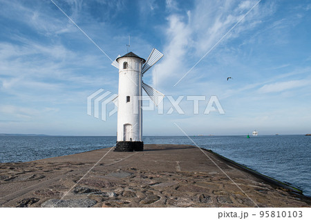 Old windmill lighthouse in Swinoujscie, a port in Poland on the Baltic Sea. Old windmill lighthouse in Swinoujscie, a port in Poland on the Baltic Sea. 95810103