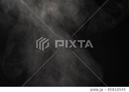 Closeup of water steam over black background Closeup of water steam over black background 95810545