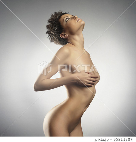 Sexy naked girl with a beautiful body posing in a photo studio. Sexy naked girl with a beautiful body posing in a photo studio. 95811207
