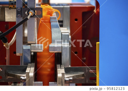 The orange bottle container manufacturing process by blow mold machine. The orange bottle container manufacturing process by blow mold machine. 95812123