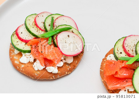 Cracker Sandwiches with Salmon, Cucumber, Radish, Cottage Cheese and Green Onions 95813071