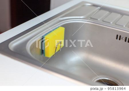Sponge for washing dishes. Storage ideas, sink in the kitchen.  95813964