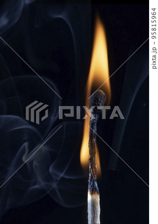 An image of a match stick flame in front of a black 95815964