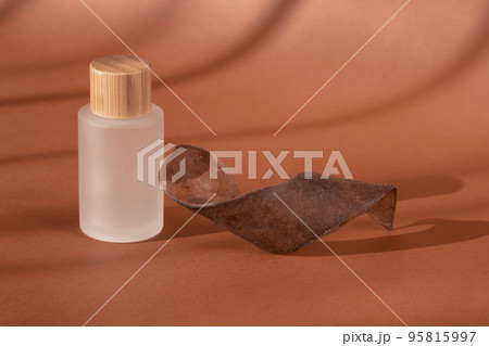 Cream beauty skincare cosmetic mockup showcase, shadow from sun. Product presentation, cosmetics brand, lotion, peptide, collagen, hyaluronic acid in glass bottle, wooden decor. Minimal 95815997