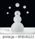 Felt snowman juggles woolen Christmas snowballs at 95816121