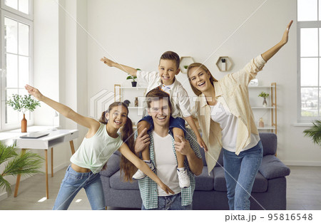 Portrait of funny young Caucasian family with children having fun and fooling around at home. Portrait of funny young Caucasian family with children having fun and fooling around at home. 95816548