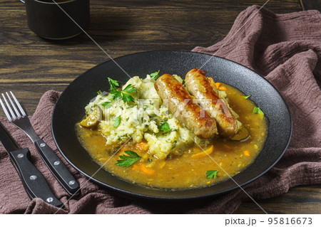 Dutch stamppot of potatoes, kale and sausages on plate 95816673