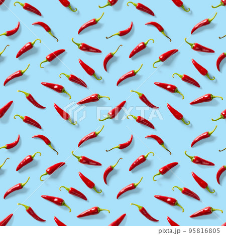 Seamless pattern made of red chili or chilli on blue background. Minimal food pattern. Red hot chilli seamless peppers pattern. Food background. Seamless pattern made of red chili or chilli on blue background. Minimal food pattern. Red hot chilli seamless peppers pattern. Food background. 95816805
