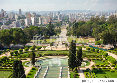 high angle view of Ipiranga Museum garden and fountains with Sao Paulo cityscape as backdrop, Brazil high angle view of Ipiranga Museum garden and fountains with Sao Paulo cityscape as backdrop, Brazil 95817660