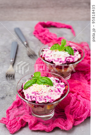 Traditional Russian salad - herring under a fur coat in bowls on the table Traditional Russian salad - herring under a fur coat in bowls on the table 95818435