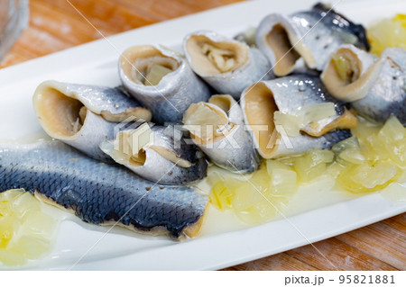 Salted pickled herring fish served on a ceramic plate 95821881