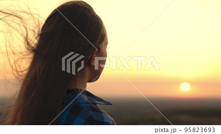 dreaming girl looks sunset. pray looking light sky. woman developing hair wind. europe world. sincere acceptance present. free life desire man. look sun outdoor. desire travel nature. female happi dreaming girl looks sunset. pray looking light sky. woman developing hair wind. europe world. sincere acceptance present. free life desire man. look sun outdoor. desire travel nature. female happi 95823693