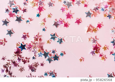 Multicolor holographic Stars Glitter Confetti on pink background. Festive backdrop, selective focus Multicolor holographic Stars Glitter Confetti on pink background. Festive backdrop, selective focus 95826568