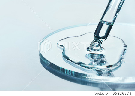 Pipette with sample of cosmetic product in petri dish on blue background, selective focus 95826573