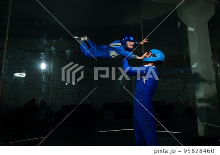 A man teaches a boy to fly in a wind tunnel. Lack of gravity. A man teaches a boy to fly in a wind tunnel. Lack of gravity. 95828460